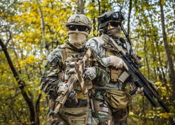 Two United states Marine Corps special operations command Marine Special Operators also known as Marsoc raiders in camouflage uniforms in the forest