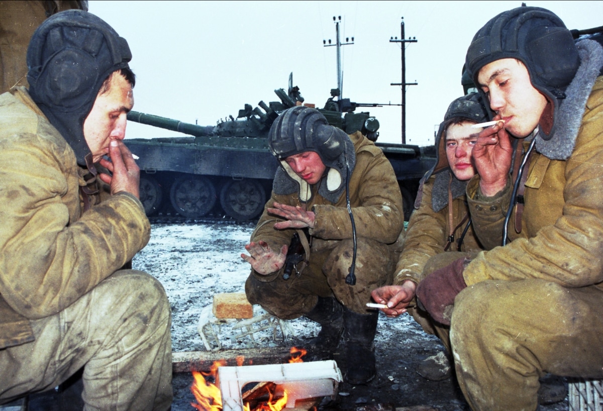 GUDERMES, CHECHNYA - JAN 16: Russian army armor troops try to keep warm, and catch a few minutes rest between fighting Chechen rebels in Gudermes, Chechnya, on Sunday, January 16, 2000.