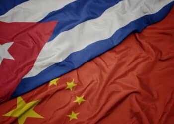 waving colorful flag of china and national flag of cuba. macro