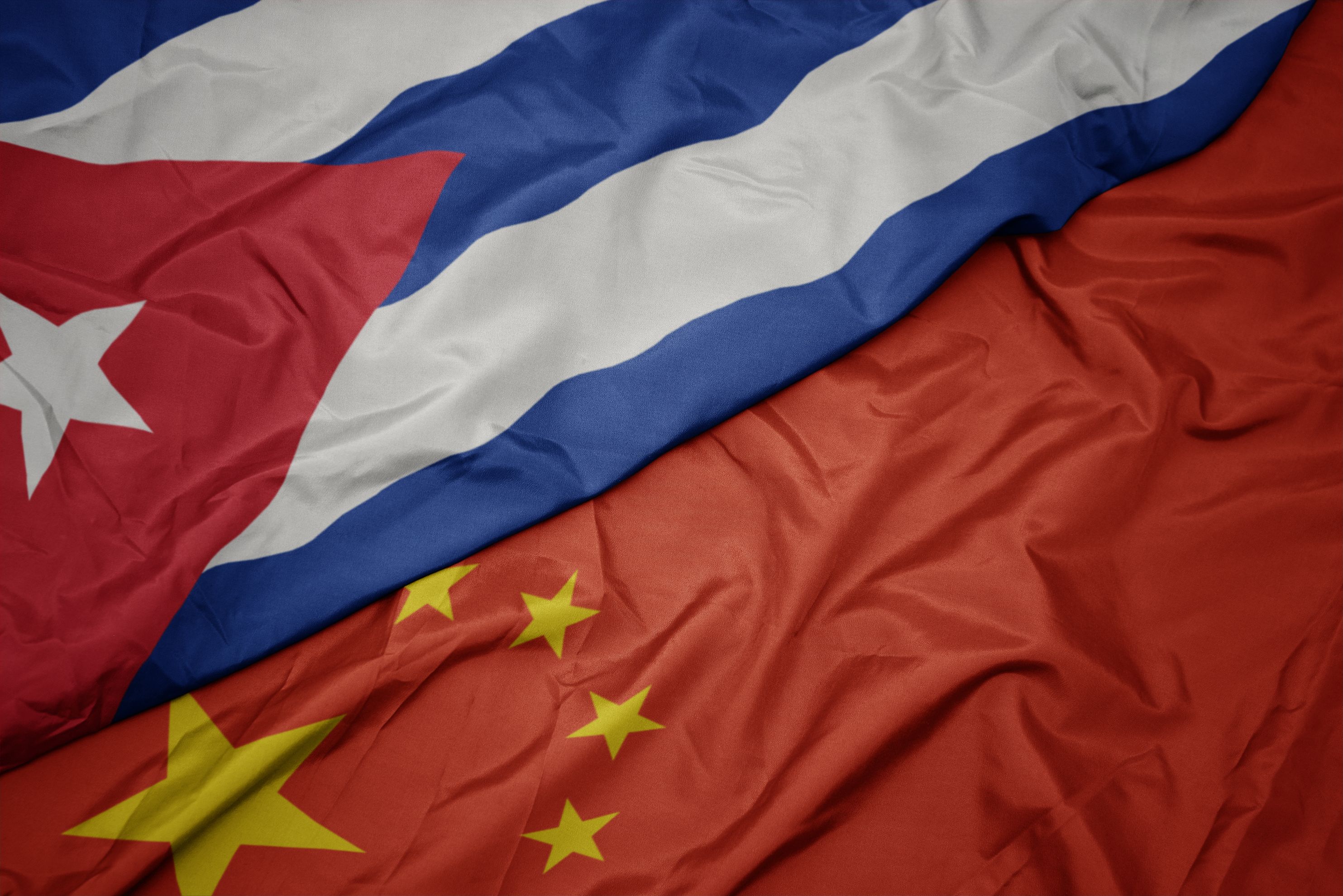 waving colorful flag of china and national flag of cuba. macro