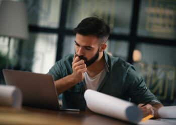 Businessman working on his laptop. Handsome young man working in office.