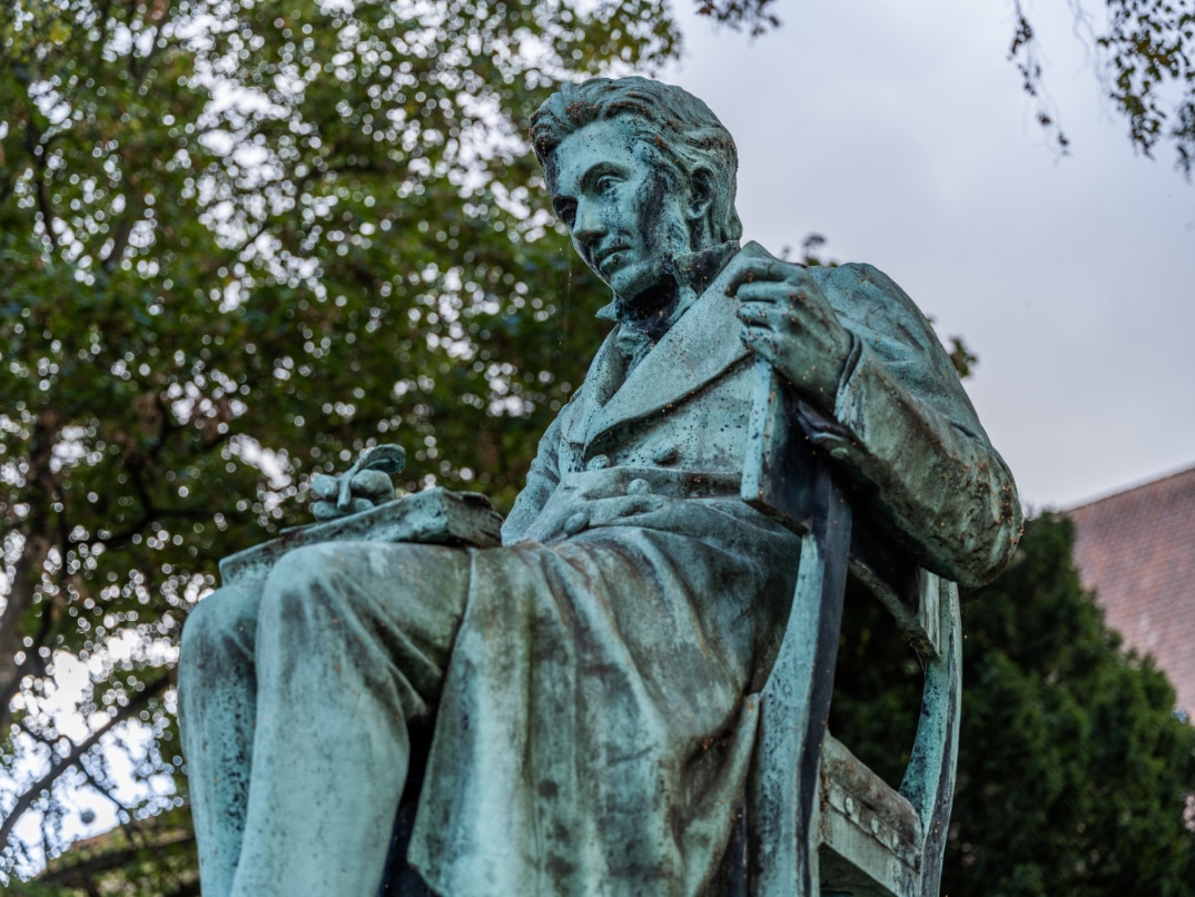 Copenhagen, Denmark - October 9 2022: Statue of Søren Kierkegaard (1813-1855) in The Royal Library Garden. Kierkegaard was a - now world famous - philosopher and writer.