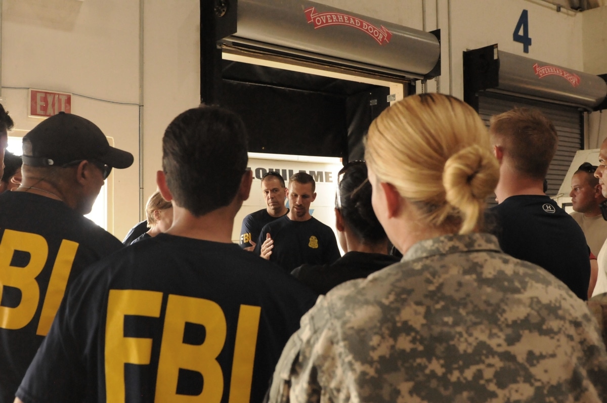 Aguas Buenas, Puerto Rico –Soldiers and Federal Bureau of Investigations special agents are briefed on convoy maneuvers during transport operations in support of Hurricane Maria relief efforts