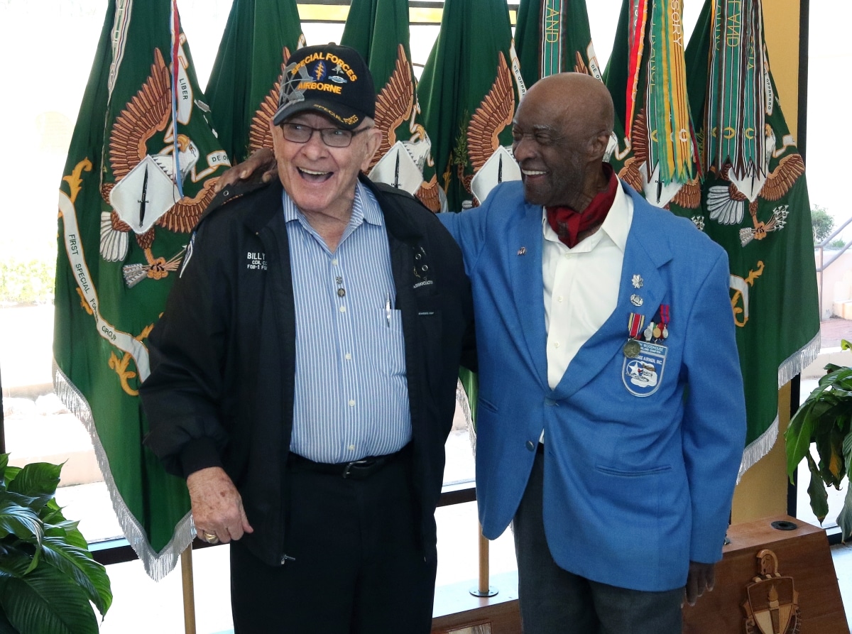 Retired Lieutenant Colonel Enoch Woodhouse II, shares a laugh with retired Sergeant Maj. William “Billy” Waugh at the U.S. Army John F. Kennedy Special Warfare Center and School auditorium following a special observance celebrating and honoring African American/Black History Month