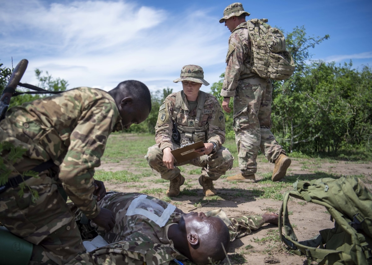 U.S. Army Staff Sgt. Elisha Waiters, instructor, 403rd Civil Affairs Battalion assigned to Combined Joint Task Force-Horn of Africa writes a team evaluation during a Counter Illicit Trafficking Junior Leadership Course examination at Queen Elizabeth Park, Uganda