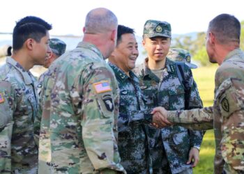 Maj. Gen. Xu Qiling, center right, Commander of Eastern Theater Command Army, People's Liberation Army, shakes hands with Brig. Gen. Joshua Rudd, far right, Deputy Commanding General of Operations