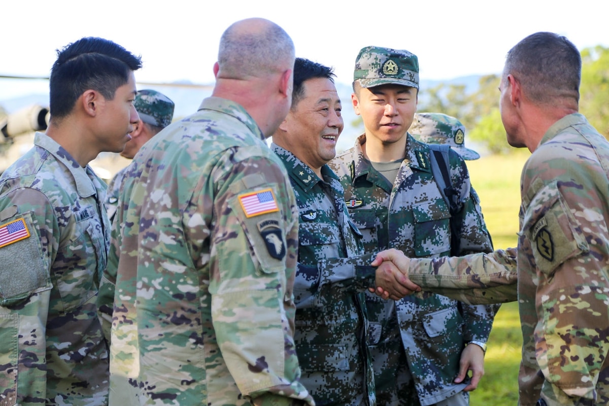 Maj. Gen. Xu Qiling, center right, Commander of Eastern Theater Command Army, People's Liberation Army, shakes hands with Brig. Gen. Joshua Rudd, far right, Deputy Commanding General of Operations
