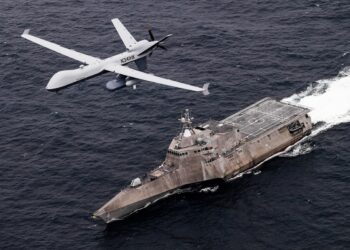 PACIFIC OCEAN (April 21, 2021) An MQ-9 Sea Guardian unmanned maritime surveillance aircraft system flies over Independence-variant littoral combat ship USS Coronado (LCS 4) during U.S.