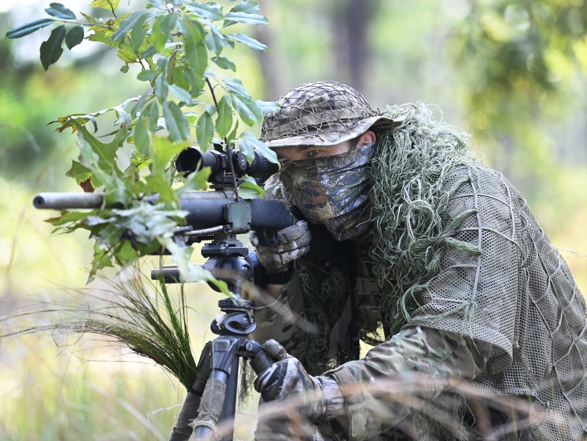 A student assigned to the U.S. Army John F. Kennedy Special Warfare Center and School who is in the Special Forces Sniper Course looks through a scope during sniper-training at Fort Bragg, North Carolina