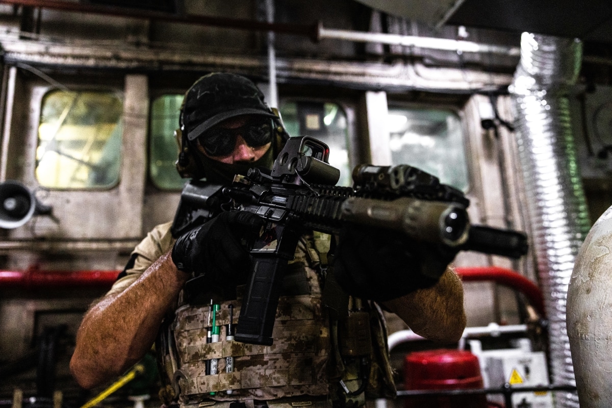 A member of US Naval Special Warfare Task Unit Europe (NSWTU-E) conducts maritime Visit, Board, Search and Seizure (VBSS) training using Colt MK 18 carbine alongside a Cypriot Underwater Demolition Team (MYK) in Cyprus