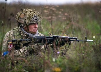 A Ukrainian paratrooper assigned to the Lithuanian - Polish - Ukrainian Brigade establishes sector security on a drop zone alongside paratroopers from 1st Battalion, 503rd Parachute Infantry Regiment after conducting a joint airborne operation.