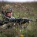 A Ukrainian paratrooper assigned to the Lithuanian - Polish - Ukrainian Brigade establishes sector security on a drop zone alongside paratroopers from 1st Battalion, 503rd Parachute Infantry Regiment after conducting a joint airborne operation.