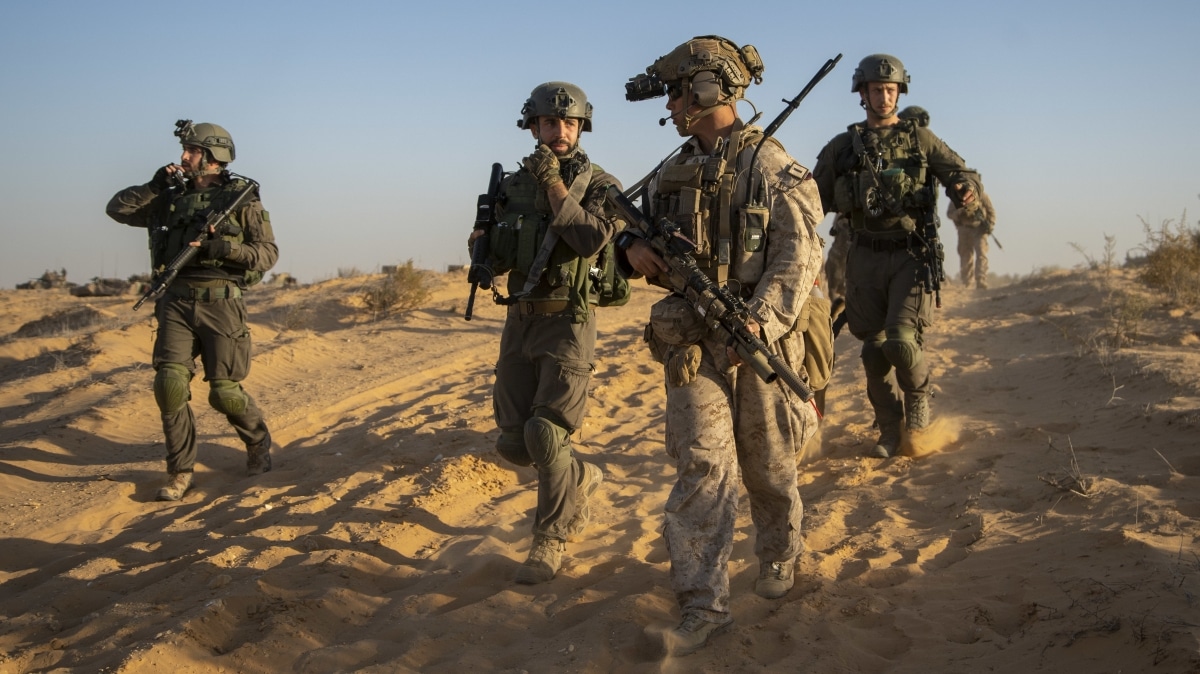 211109-M-PO838-1065 MALA NATIONAL TRAINING CENTER, Israel (Nov. 9, 2021) Marine Corps 1st Lt. Matthew Williams, center right, a platoon commander assigned to Alpha Company, Battalion Landing Team 1/1, 11th Marine Expeditionary Unit, moves to a staging area with Israel Defense Forces soldiers during a combined urban assault