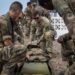 U.S. Army Staff Sgt. John Hampson, an instructor at the U.S. Army Mountain Warfare School, instructs French service members with the 5th Overseas Interarms Regiment (5e RIAOM) on casualty evacuation techniques at the French Combat Training Center at Arta Beach, Djibouti