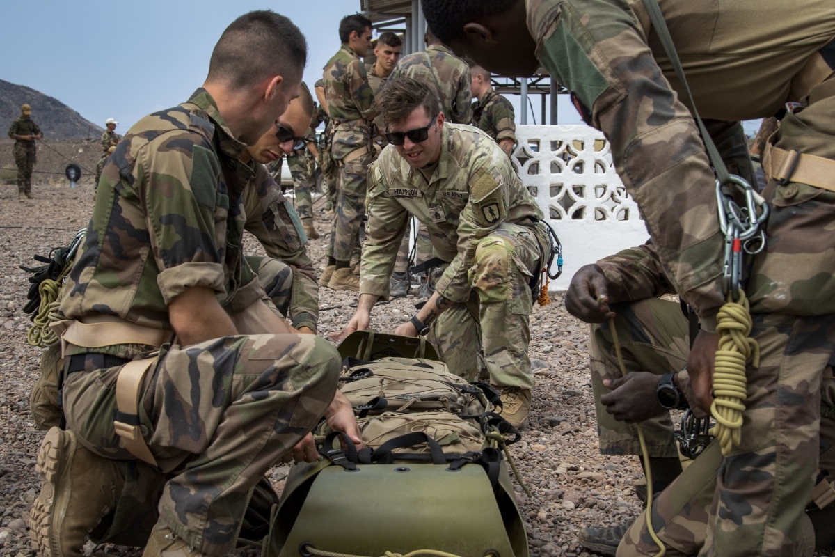 U.S. Army Staff Sgt. John Hampson, an instructor at the U.S. Army Mountain Warfare School, instructs French service members with the 5th Overseas Interarms Regiment (5e RIAOM) on casualty evacuation techniques at the French Combat Training Center at Arta Beach, Djibouti