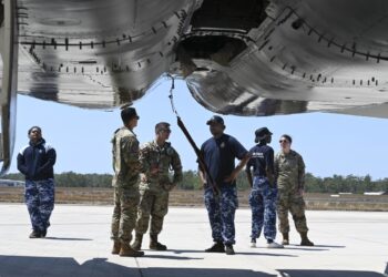 U.S. Airmen from the 67th Aircraft Maintenance Unit speak to Royal Australian Air Force Indigenous Youth Program members during their visit to RAAF Base Darwin