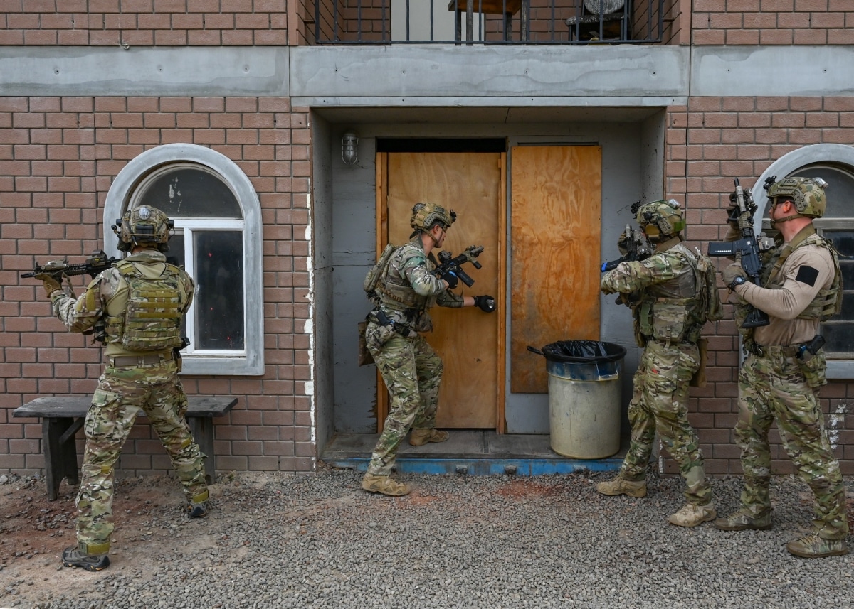 SAN DIEGO (Dec. 1, 2022) U.S. Navy and Republic of Korea Navy SEALs prepare to enter a building while conducting a fully integrated target assault scenario as part of military operations in urban terrain practice during a bilateral training exercise.