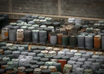 Photo of a Chemical waste dump with a lot of barrels