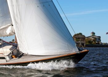 Sailing in Newport Harbor on a windy day in Rhode Island. The Narragansett Bay region is a world class destination for tourists who enjoy sailing. It is known as the sailing capital of the world.