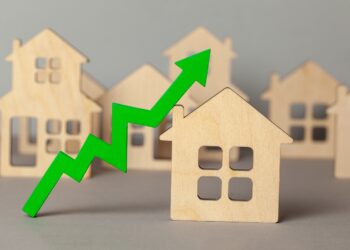 Up arrow and many houses. Growth in real estate prices market. Buying and selling house.