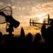Silhouettes of satellite dishes or radio antennas against night sky. Space observatory or Air defence radar over dramatic sunset sky. Creative artwork decoration. Selective focus