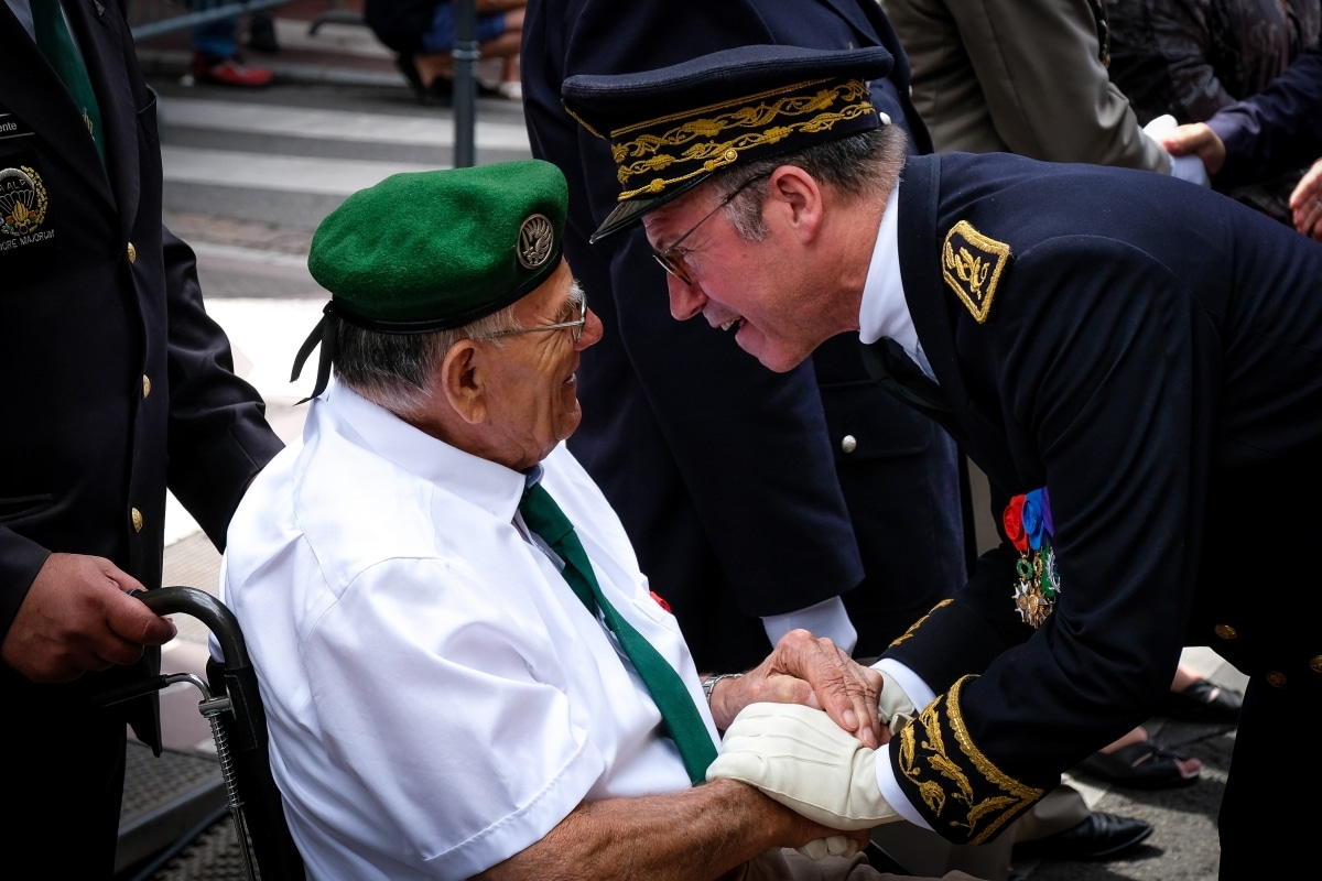 TOULOUSE, FRANCE - JULY 14: a senior officer talking with a green beret retired during the French paratroopers and police forces parade during the celebration of the 14 of july, bastille day