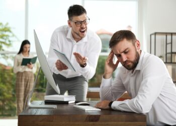 Boss screaming at employee in office. Toxic work environment