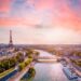 Paris aerial panorama with river Seine and Eiffel tower, France. Romantic summer holidays vacation destination. Panoramic view above historical Parisian buildings and landmarks with sunset sky