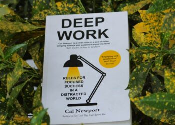 Uttarakhand, India - Feb 26, 2023: Close up of Deep Work book by Cal Newport in a green-yellow leaves