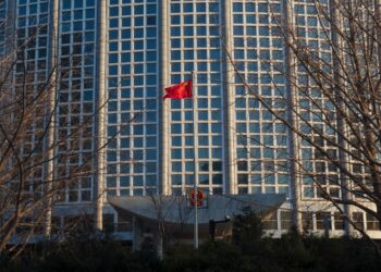 BEIJING, CHINA - FEBRUARY 4, 2023: Chinese National flag flutter at the Headquarters of the Ministry of Foreign Affairs of the People's Republic of China.