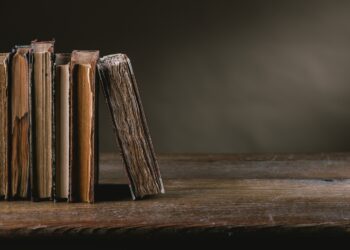Ancient books on a ruined old table still life, literacy and wisdom concept