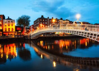 Dublin, Ireland. Night view of famous illuminated Ha Penny Bridge in Dublin, Ireland