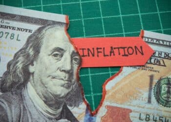 Tear off US dollar bill banknote as deep pit with word INFLATION. The Federal Reserve ( FED ) increase % interest rates to fix inflation crisis. World global economy recession and stagflation concept.