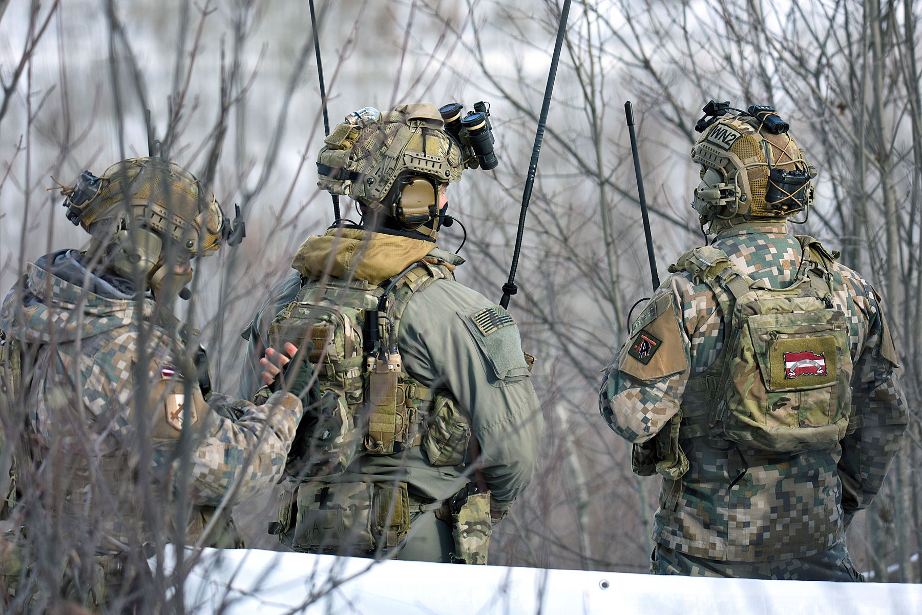 Military personnel from the Latvian National Armed Forces work side-by-side with U.S. Army Soldiers assigned to Battery C, 1st Battalion, 120th Field Artillery Regiment, Wisconsin Army National Guard, while conducting close air support training during Northern Strike 22-1