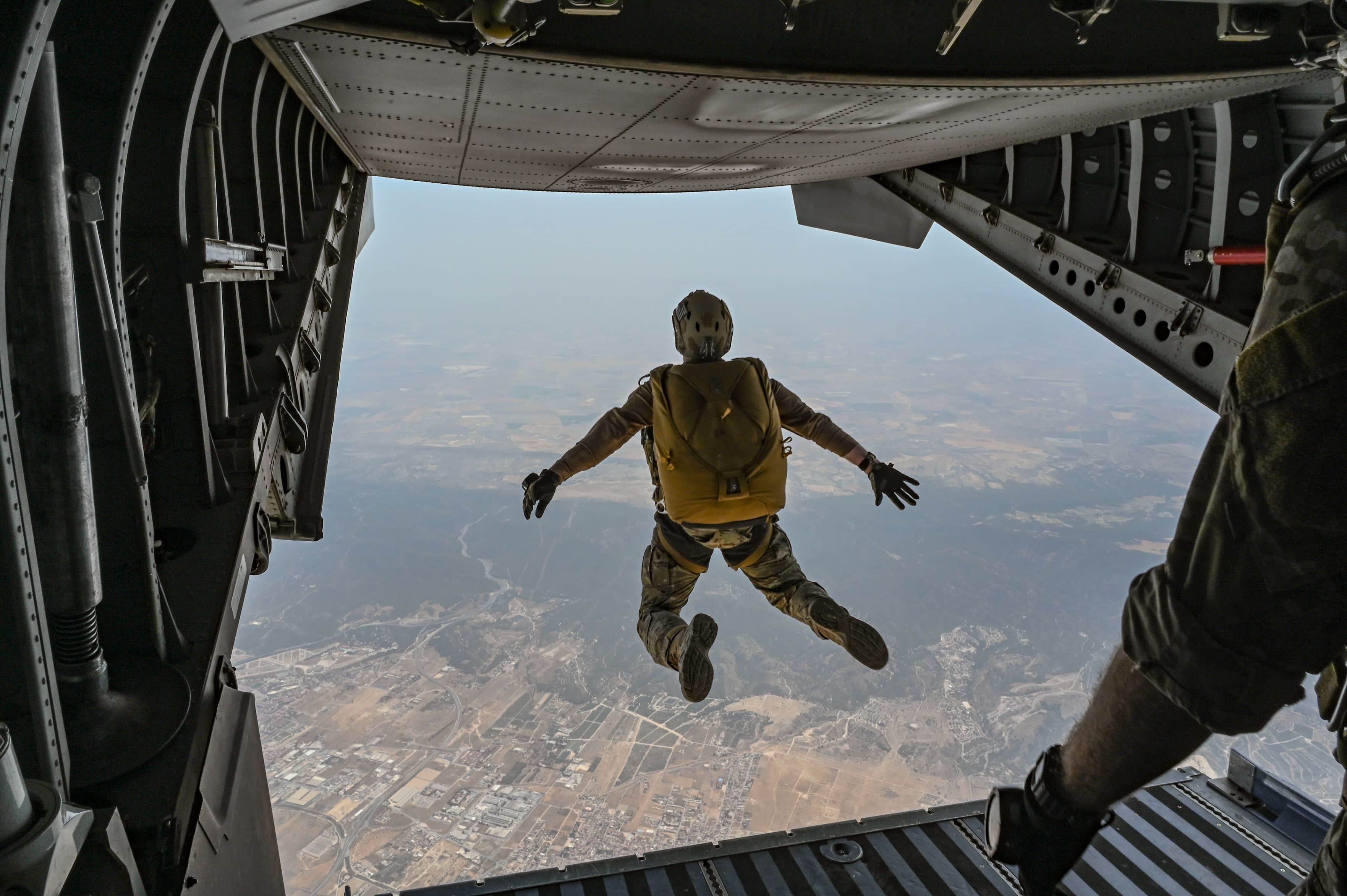 A U.S. Air Force Special Tactics operator assigned to the 352d Special Operations Wing and members of El Escuadron de Zapadores Paracaidistas (EZAPAC) execute a military free fall from a Spanish C-295 aircraft assigned to the 35 Tactical Transport Wing