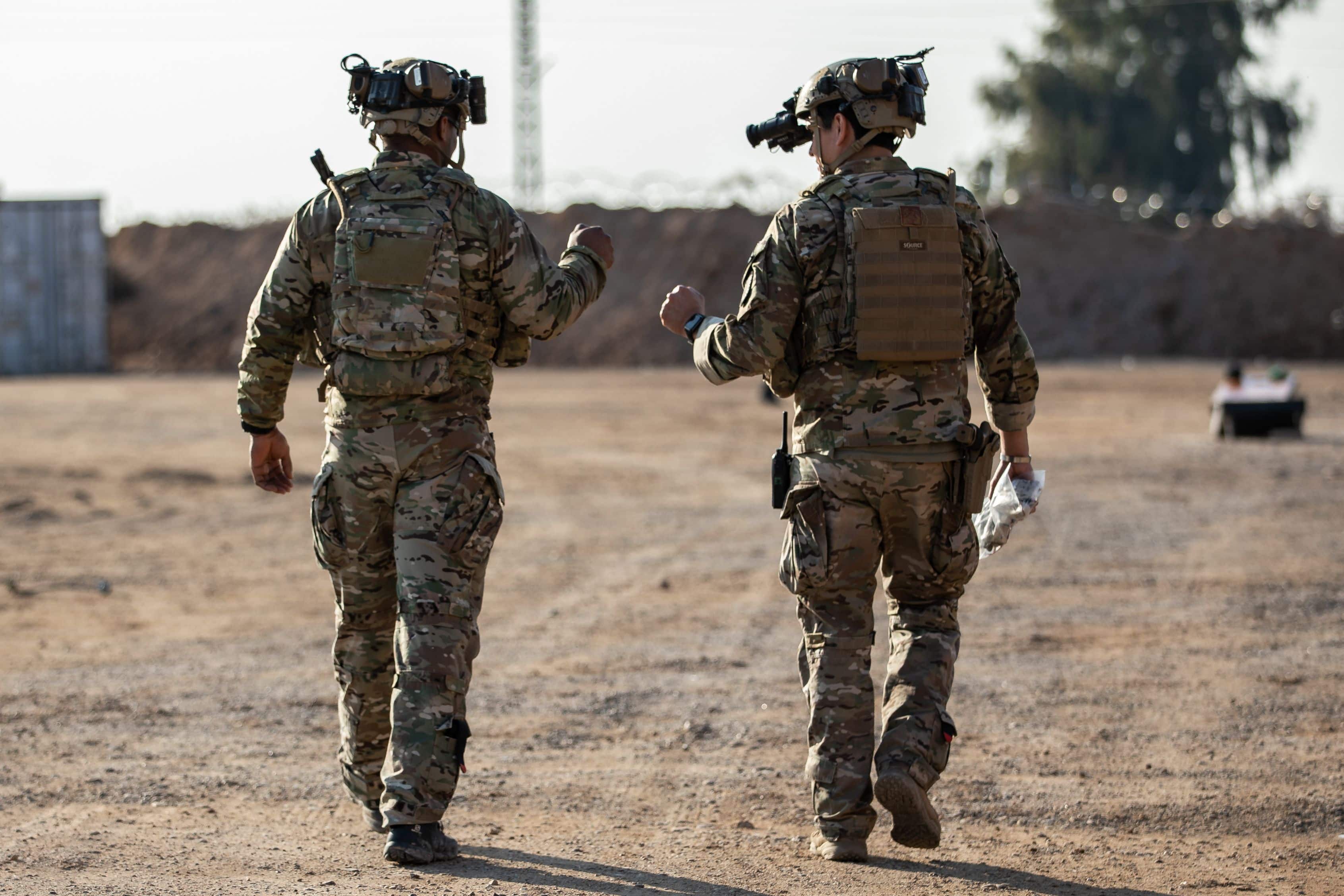 U.S. Army Sgt. Adrien Cox, left, and Staff Sgt. Jake Hankins, right, both assigned to the 717th Ordnance Company, share a fist bump during an operation with Syrian Democratic Forces in the ar-Raqqah region