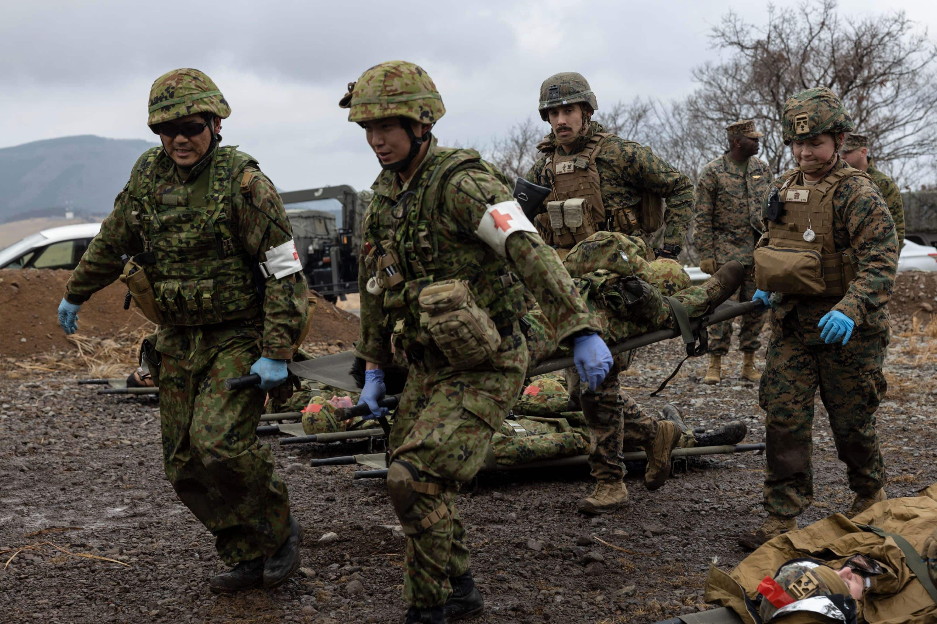 U.S. Navy corpsmen with the 31st Marine Expeditionary Unit, and soldiers with the 1st Amphibious Rapid Deployment Regiment, Japan Ground Self-Defense Force, carry a simulated casualty on a stretcher during a mass casualty exercise at Hijudai, Japan