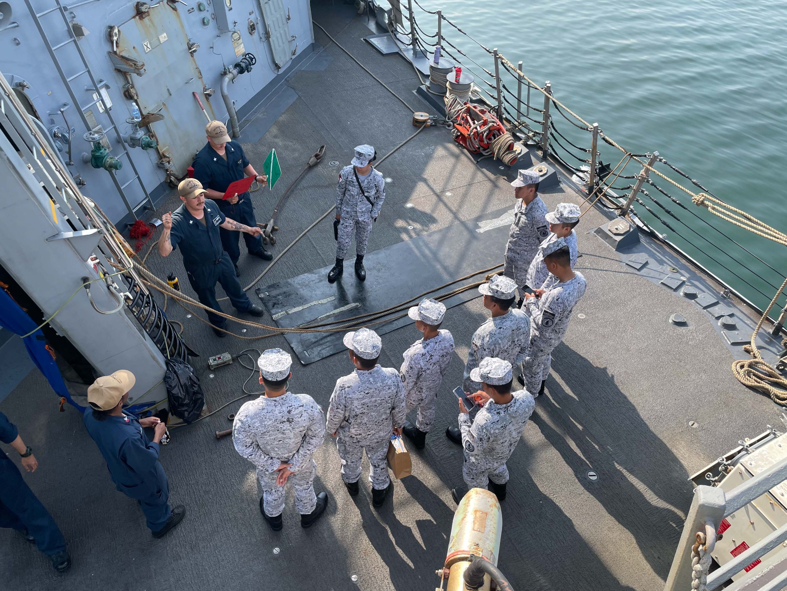 SUBIC BAY, PHILIPPINES (April 17, 2023) Boatswain’s Mate 2nd Class Josemaria Garcia gives underway replenishment training to Philippine Navy Sailors assigned to the Phoang-class corvette BRP Conrado Yap