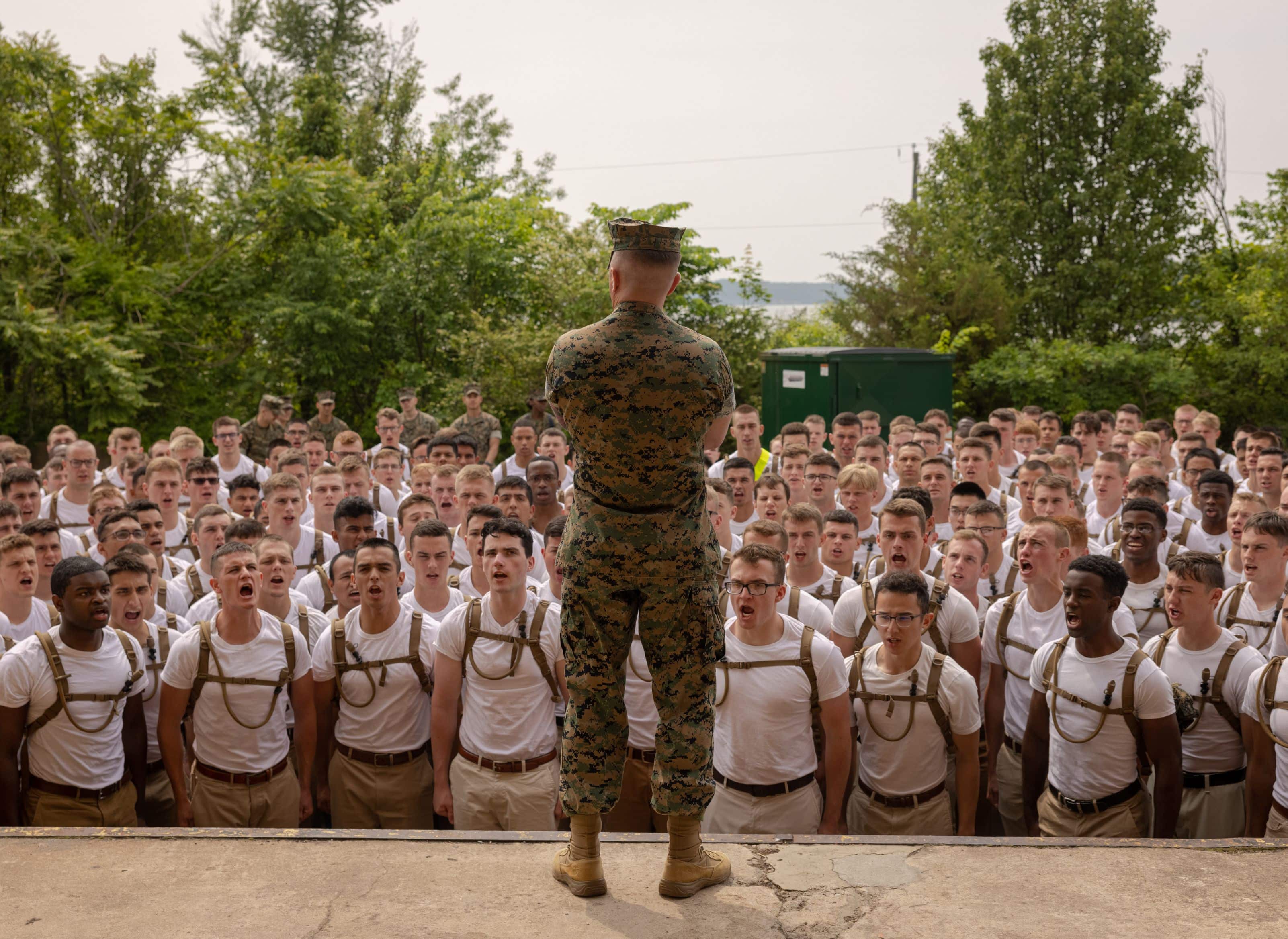 U.S. Marine Corps Gunner Sgt. James Miller, drill master, Officer Candidate School (OCS), a Native of Rowing Meadows, IL, addresses candidates during a uniform issue on Marine Corps Base Quantico, May 23, 2023. The candidates were fitted for their uniforms with the help of Marine Corps and civilian staff.