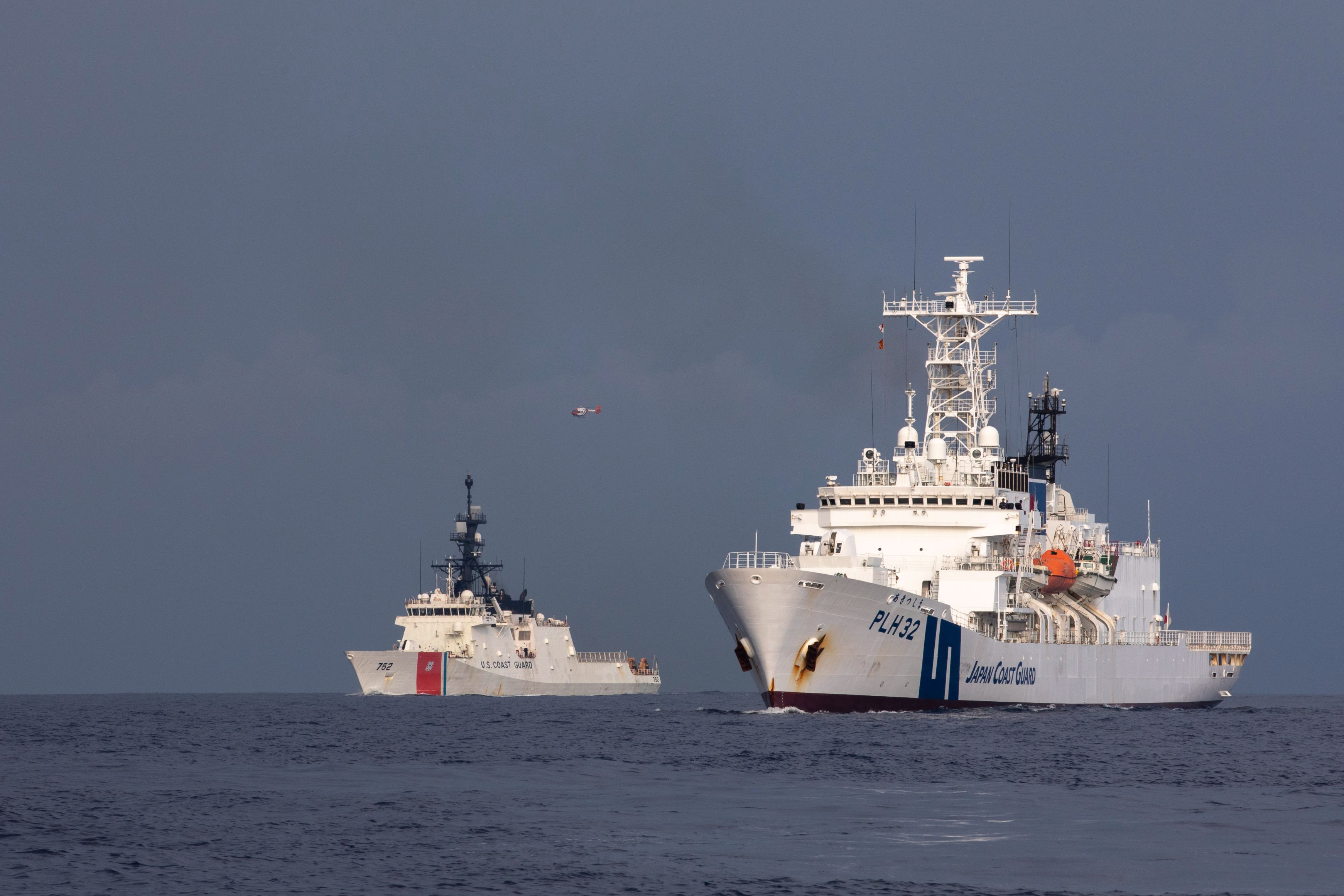 (From right) Japan Coast Guard Vessel Akitsushima (PLH 32) and U.S. Coast Guard Cutter Stratton (WMSL 752) conduct a trilateral engagement with the Philippine Coast Guard in the South China Sea