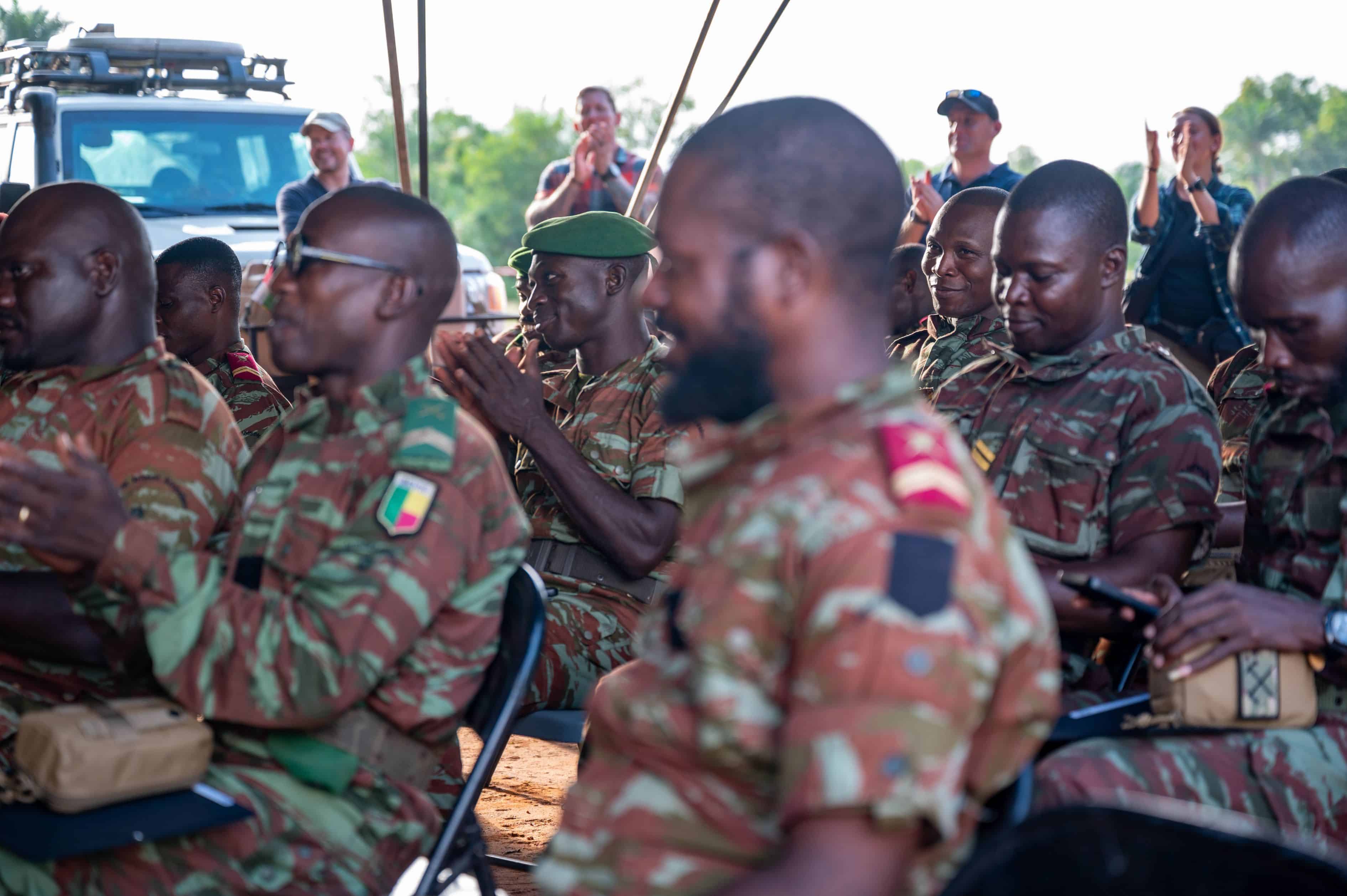 Benin Armed Forces soldiers applaud during a graduation ceremony for members that participated in a Civil Affairs Joint Combined Exchange Training