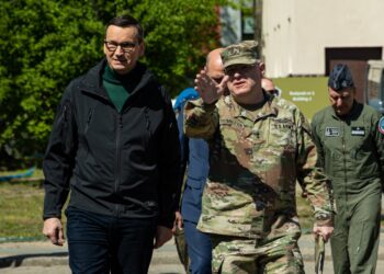 U.S. Army Maj. Gen. Timothy N. Thombleson, right, deputy commanding general of support of V Corps, walks alongside Prime Minister Mateusz Morawiecki