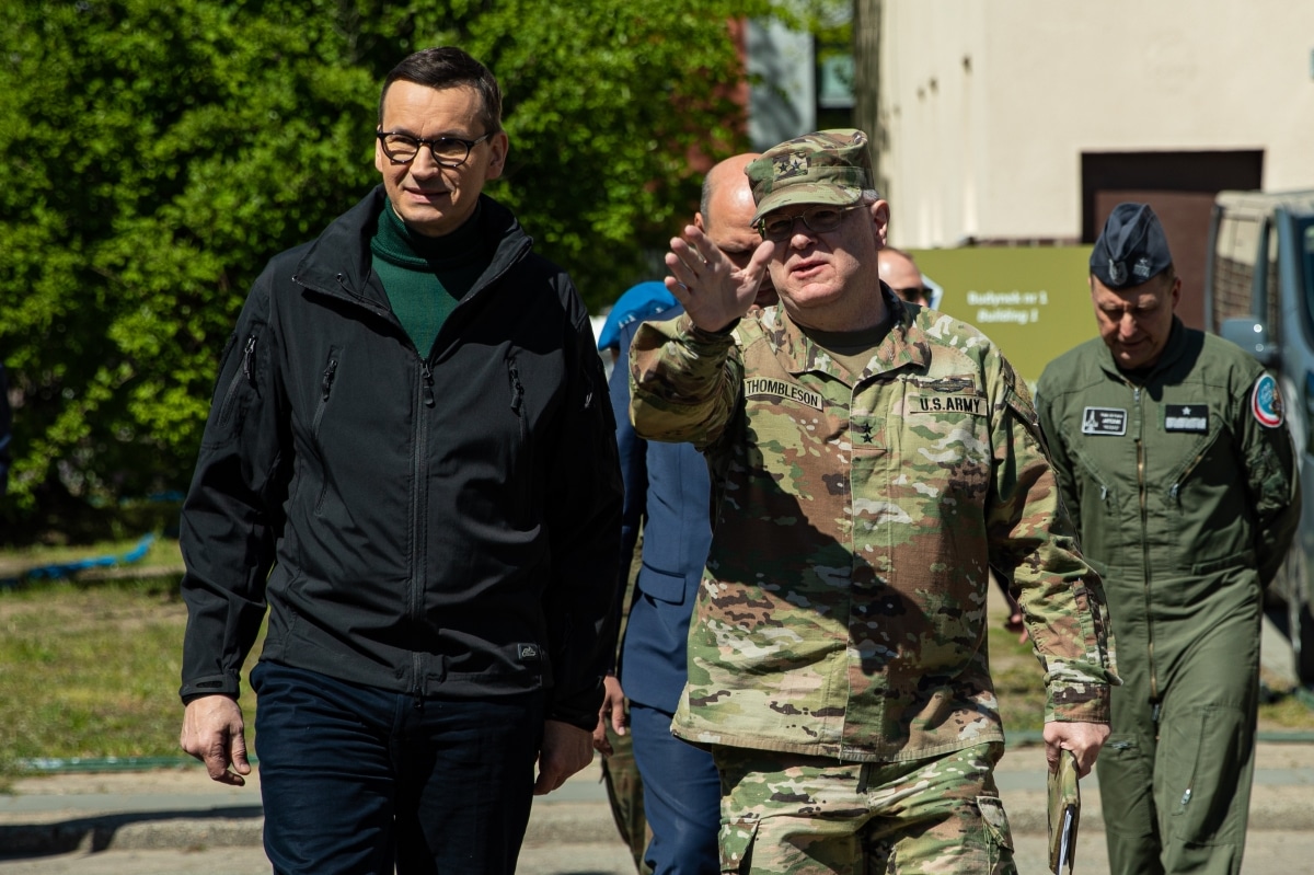 U.S. Army Maj. Gen. Timothy N. Thombleson, right, deputy commanding general of support of V Corps, walks alongside Prime Minister Mateusz Morawiecki