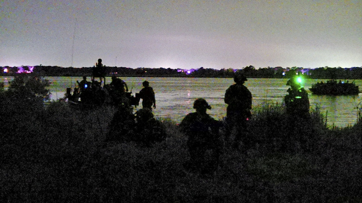 Marine Raiders with Marine Forces Special Operations Command conduct a nighttime amphibious assault with support from Naval Special Warfare Command, during Exercise Raven, a unit readiness exercise, May 23, 2023. Exercise Raven is a training exercise held to evaluate all aspects of a Marine Special Operations Company prior to a special operations deployment. (U.S. Marine Corps photo by Cpl. Henry Rodriguez)