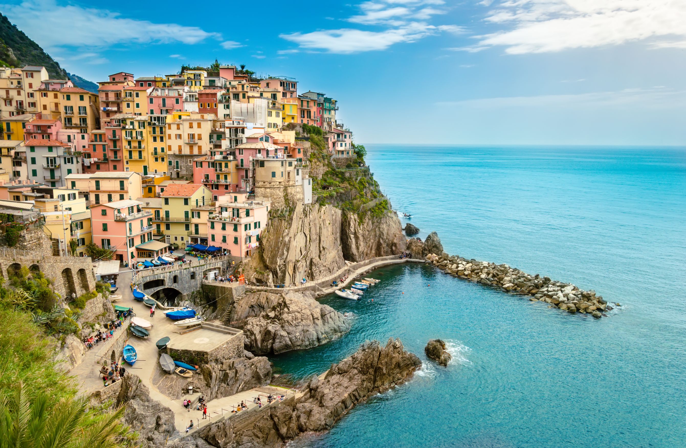 Manarola, Cinque Terre - romantic small village with colorful buildings on cliff overlooking sea. Cinque Terre National Park with rugged coastline is famous tourist destination in Liguria, Italy