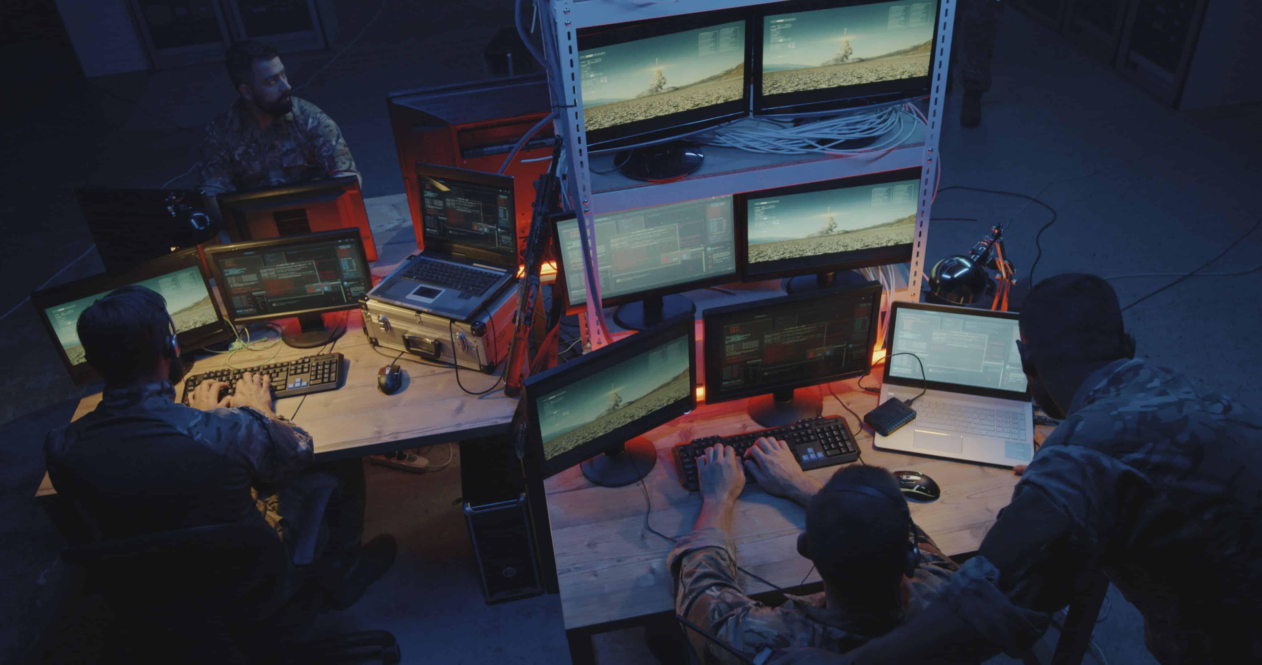 Medium shot of soldiers controlling rocket strike on computer