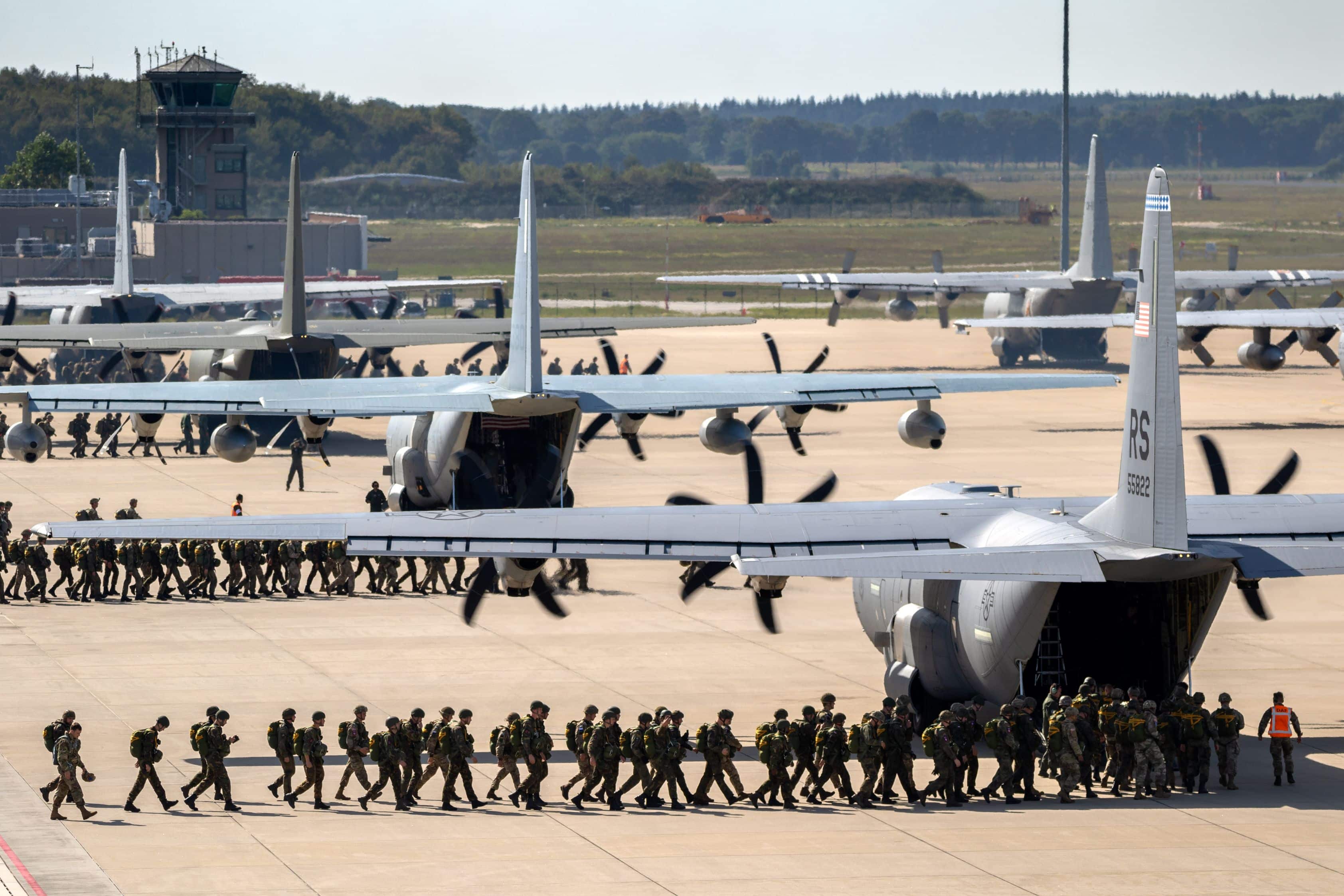 EINDHOVEN, NETHERLANDS - SEP 20, 2019: Paratroopers entering a US Air Force C-130 Hercules transport plane on Eindhoven airbase.