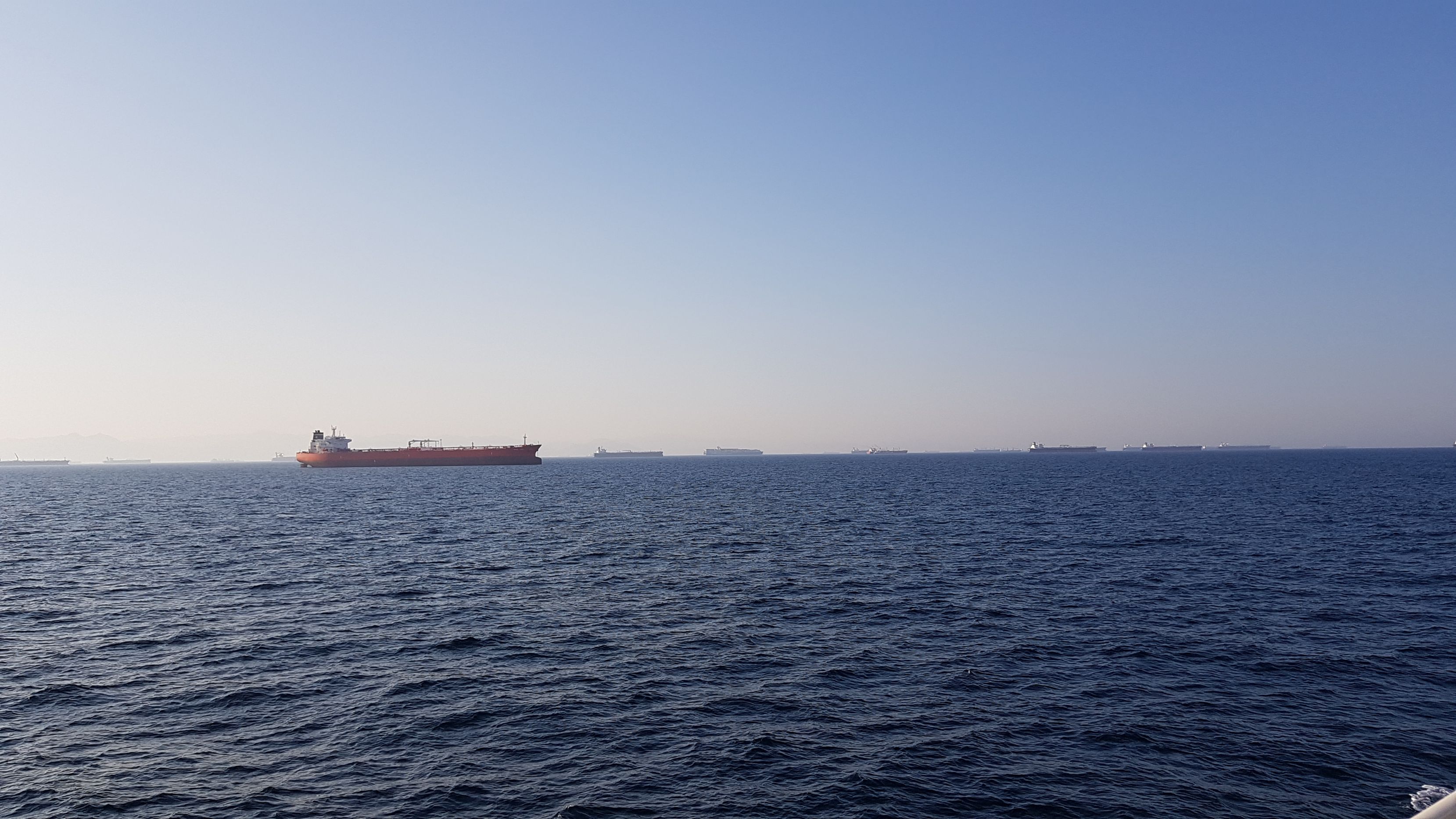 countless cargo ships in the strait of hormuz