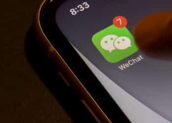 Portland, OR, USA - Aug 19, 2021: Finger touching WeChat app icon with unread message badge on an iPhone. Tencent's WeChat is a Chinese multi-purpose messaging, social media and mobile payment app.