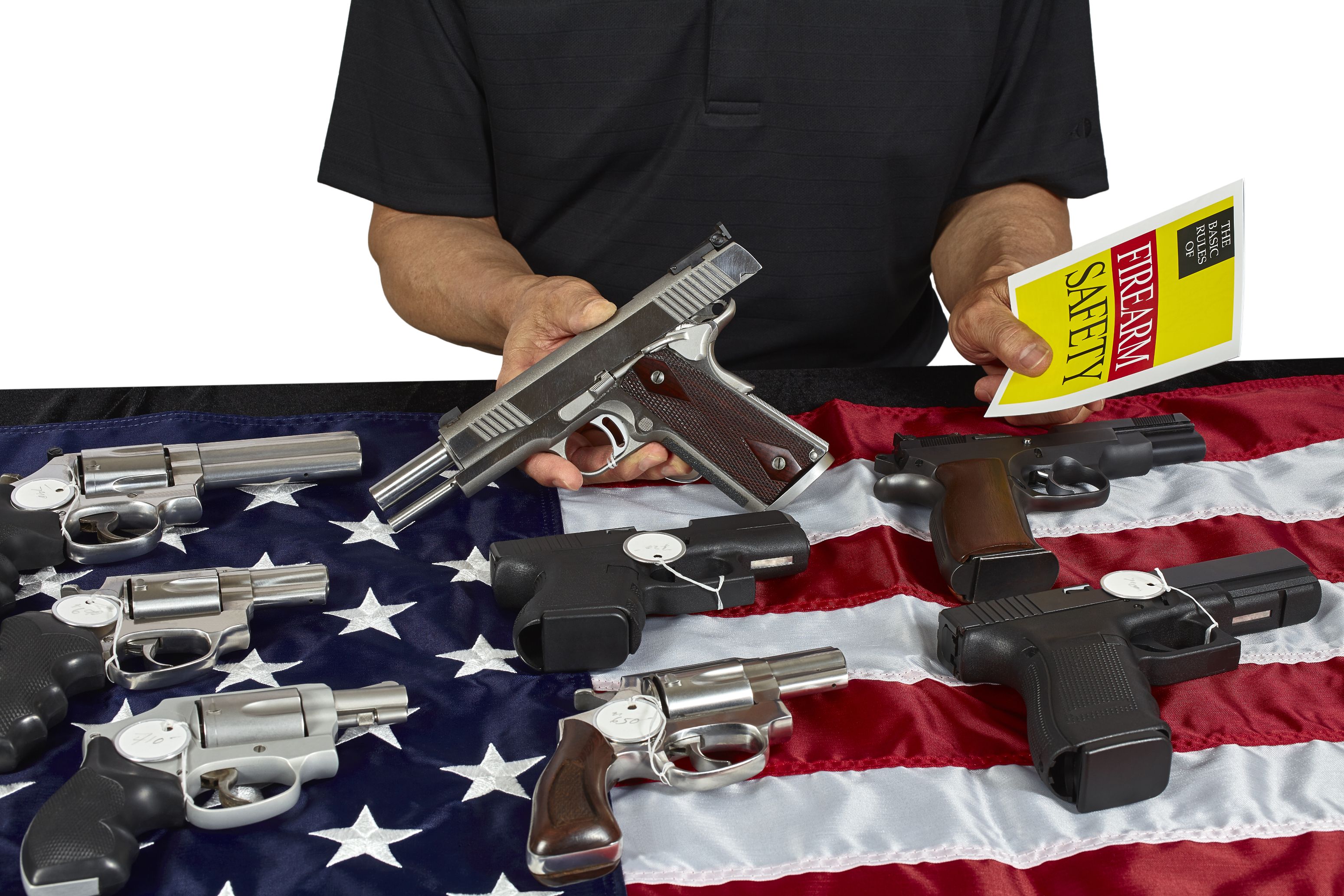 Pistols and revolver assorted firearms for sale on USA America flag at gun show